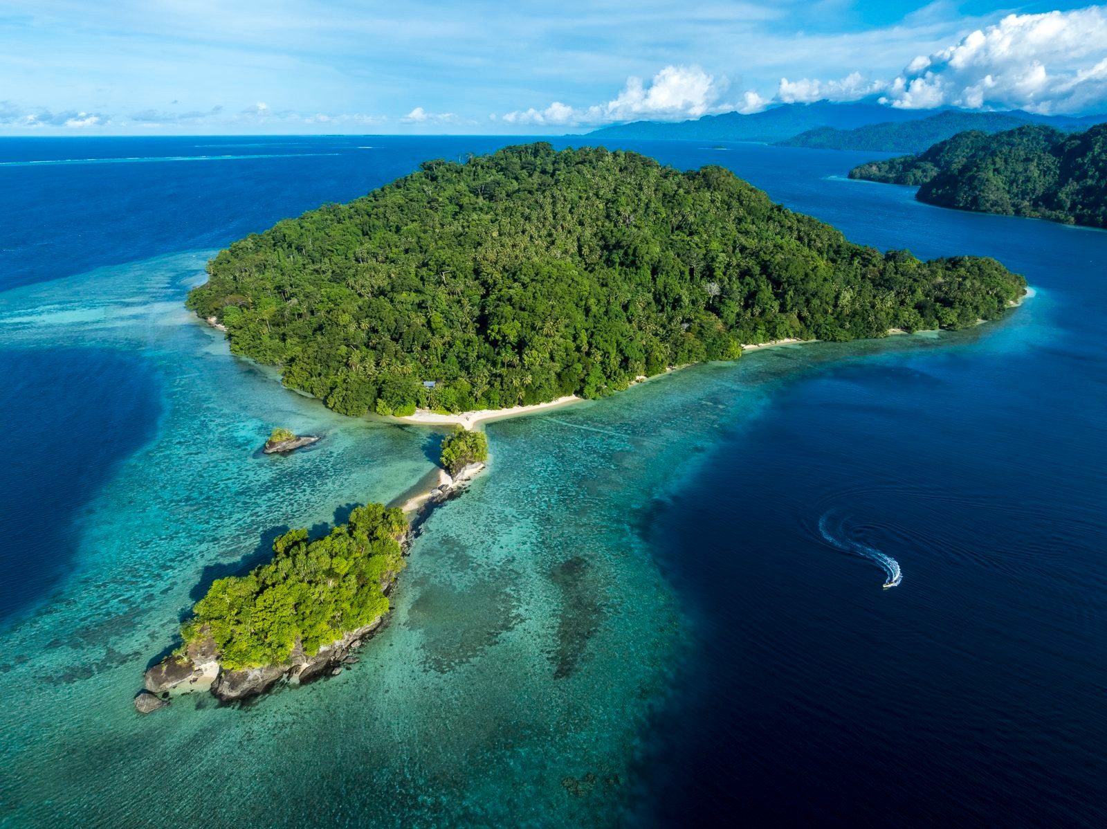 Aerial view of forested islands and coral reefs off Bougainville