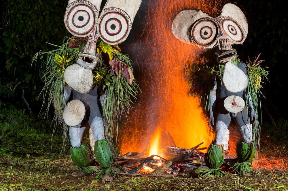Baining fire dancers with giant masks