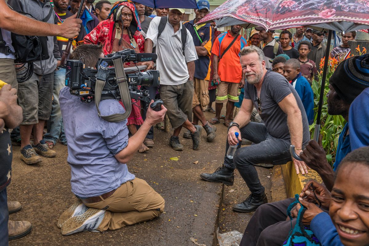 TV crew filming a presenter among a crowd in a Highlands town