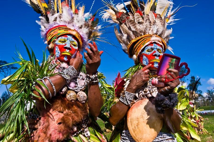 Dancers in feather headdresses at a Highlands show