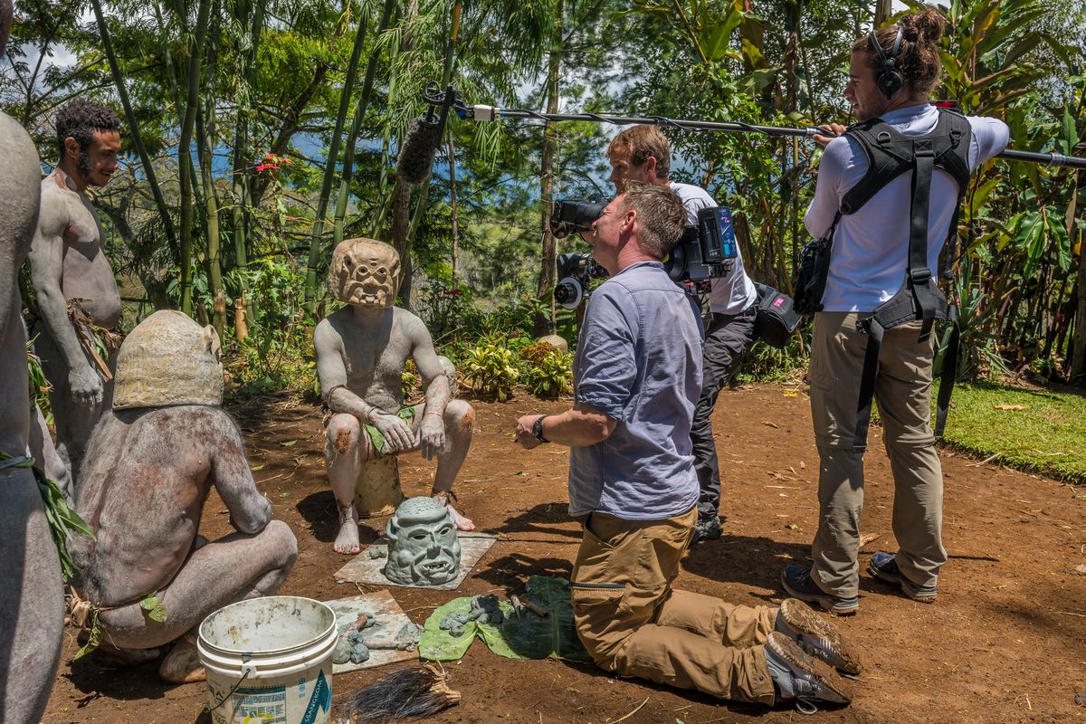 Film crew recording the Asaro mudmen shaping their clay masks, Papua New Guinea