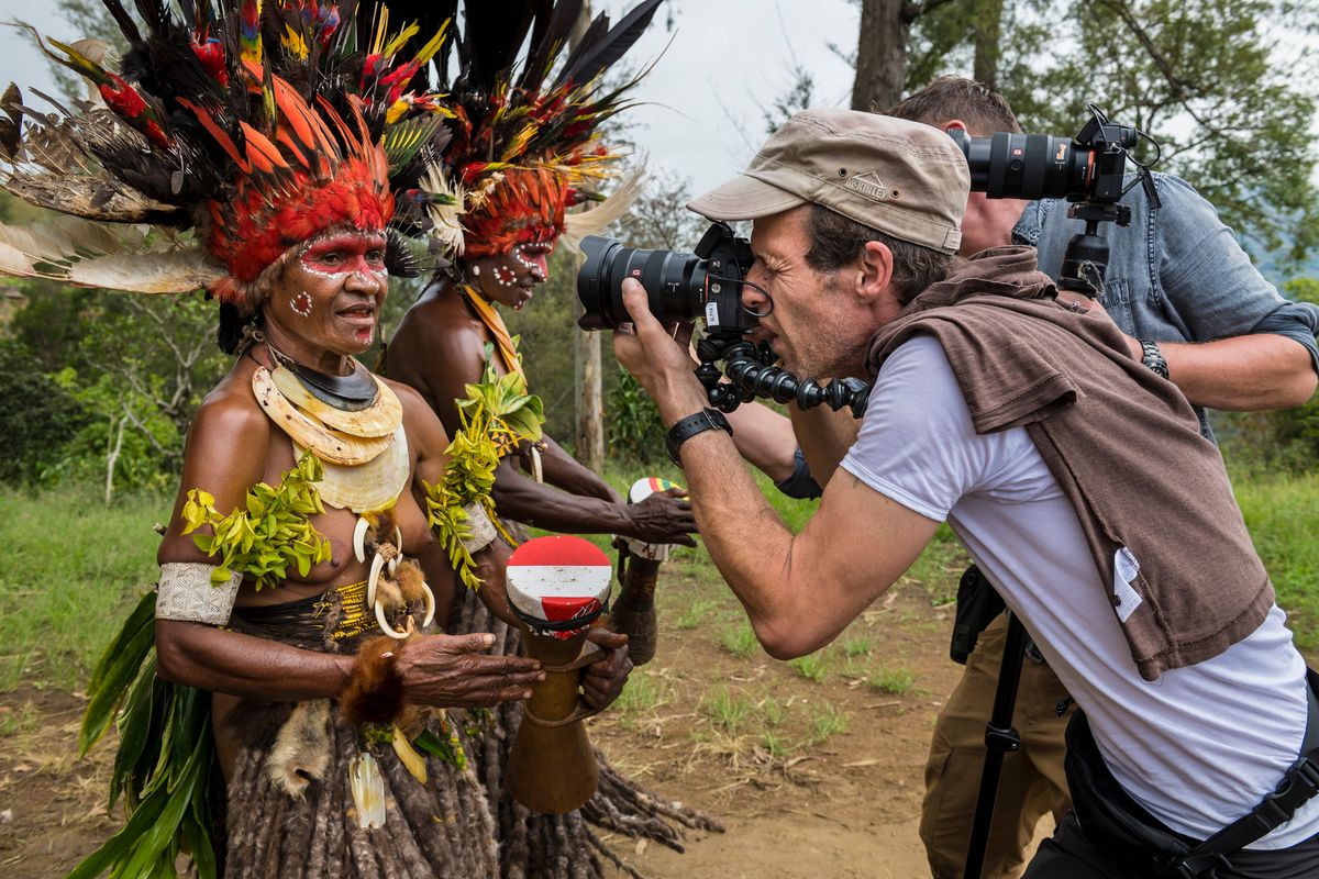 Stills photographer and camera operator with Highlands dancers in feather headdresses