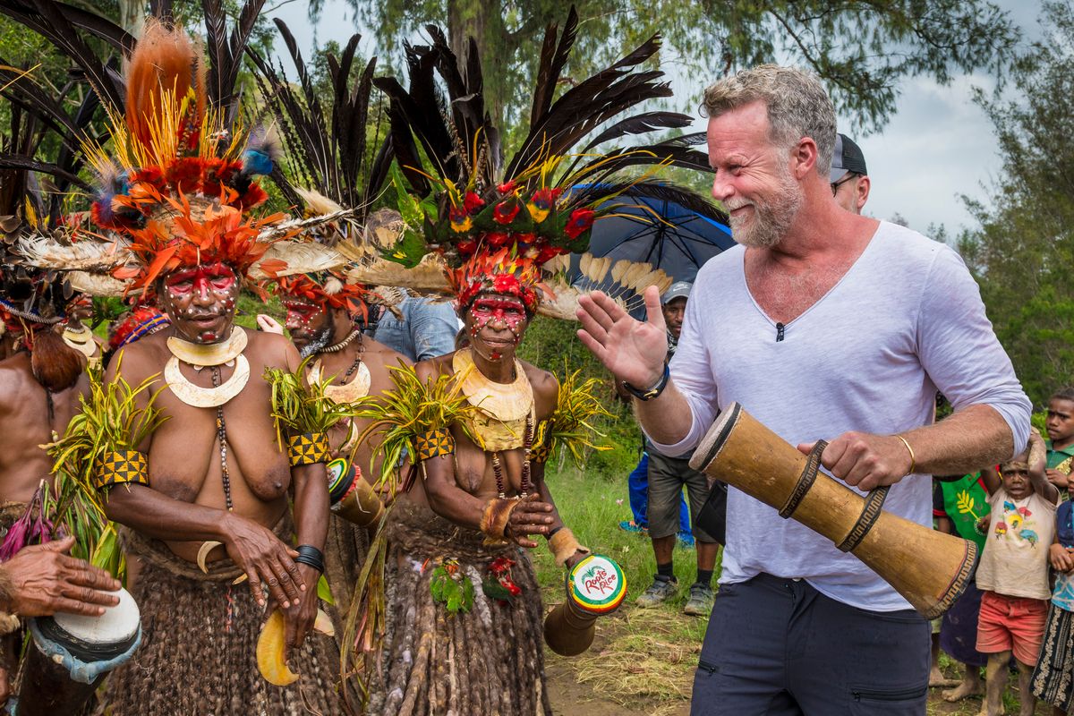Presenter joining Highlands women dancers with a kundu drum