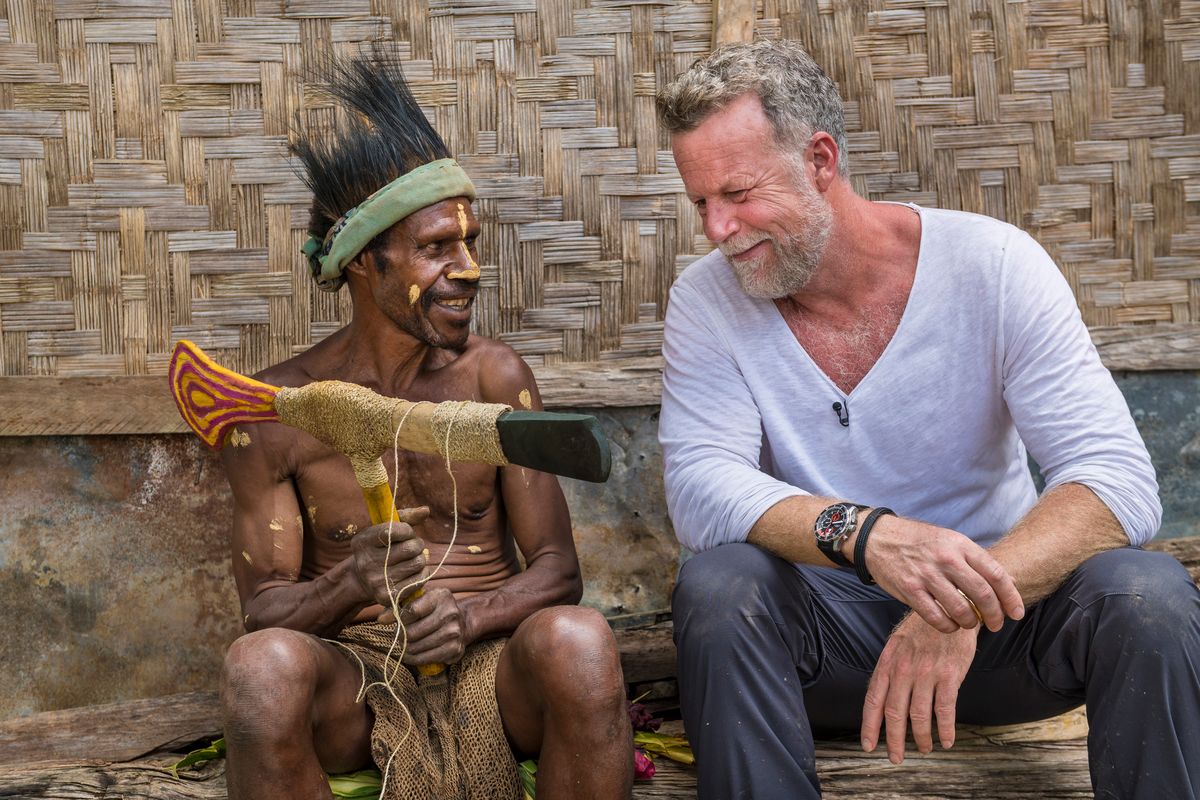 Presenter with a Highlands man holding a ceremonial stone axe