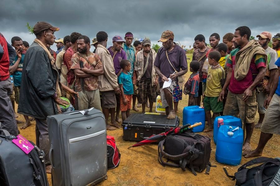 Villagers gathered around a film crew’s equipment on arrival